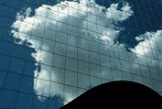 nuvens reflectidas em janelas de edificio